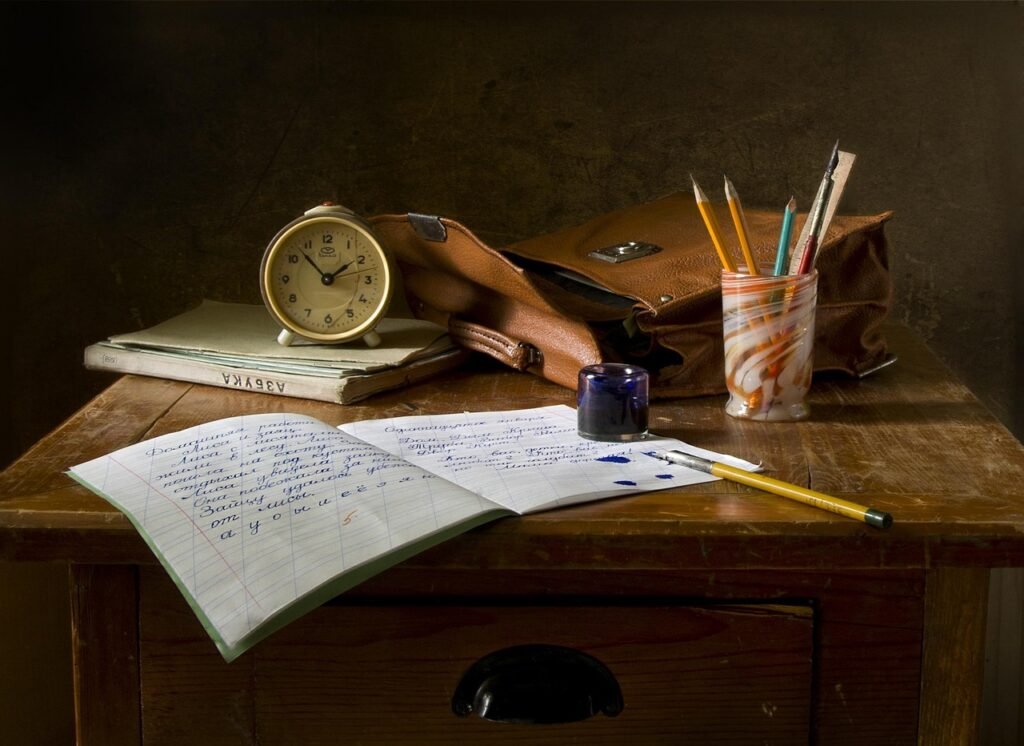 A middle school classroom desk with a closed laptop, a pencil and lined paper, representing a Maryland school district's ban on student use of AI, October 2026