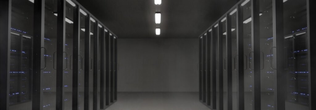 A dimly lit data centre aisle with server racks, illustrating the weak-password database breach at an Indian public university reported by Unit 42