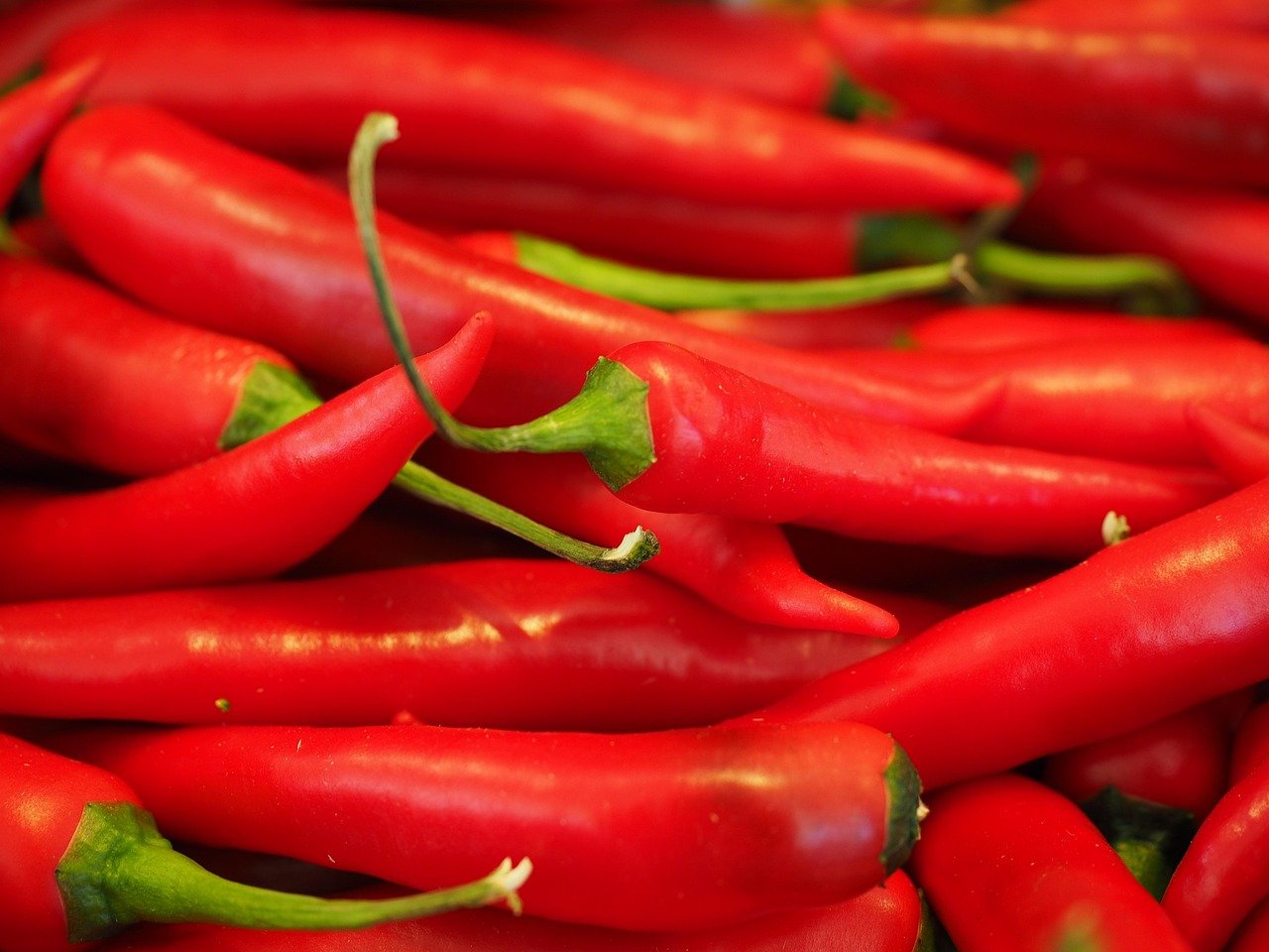 Stock photograph of red chilli peppers on a market stall, illustrating the October 2026 dispute over AI-driven pepper sorting at Chinese chilli sauce maker Lao Gan Ma