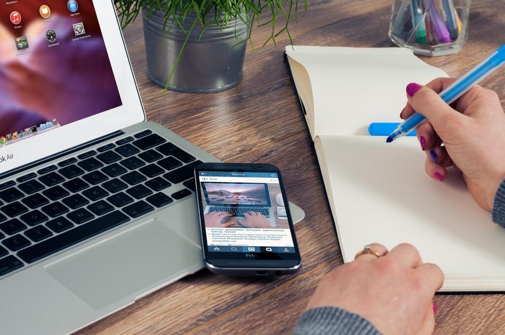 Stock photograph of laptops and monitors on desks in a technology company workspace, illustrating Amazon's October 2026 devices-unit software layoffs