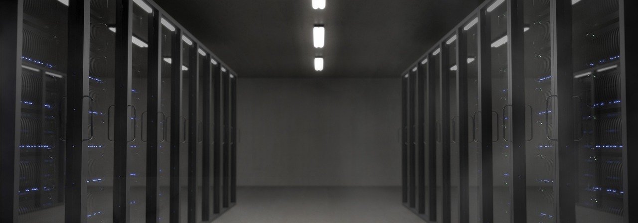 Stock photograph of a darkened server room with illuminated network cabling, illustrating the October 2026 Pentagon AI agent breach